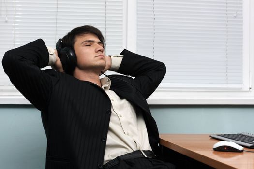 Relaxed businessman having a break at his working place