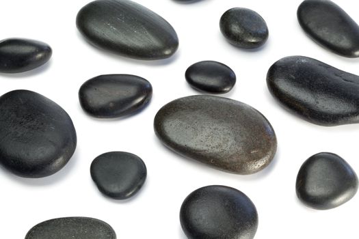 Spaced out pebbles lying on a white background