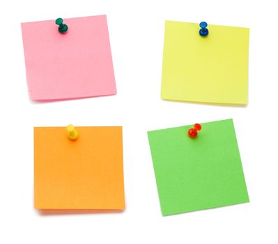 Color post-its with drawing pins on a white background