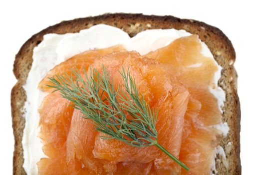 A healthy smoked salmon on a whole wheat bread with sour cream and blini on the top