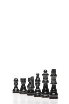 Dark pieces of chess on a white background