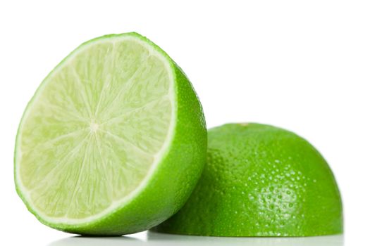 Green halved lemon on a white background