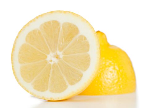 Yellow halved lemon on a white background