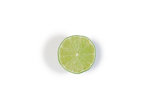 Half green lemon on a white background