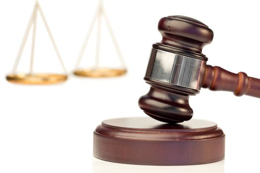 Brown gavel and scale of justice on a white background