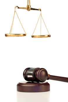 Fixed gavel and scale of justice on a white background