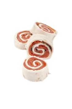 Close up image of smoked salmon rolls against white background