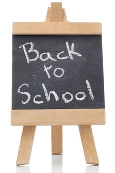 Chalkboard with the words back to school written on it isolated against a white background