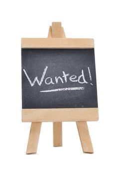 Chalkboard with the word wanted written on it isolated against a white background