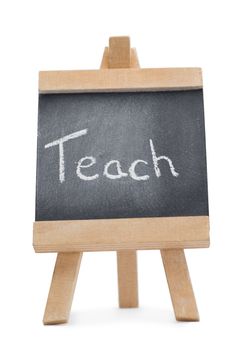 Chalkboard with the word teach written on it isolated against a white background
