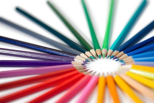 Angled color pencils star on a white background