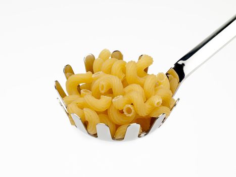 A ladle filled with dry spirali pasta