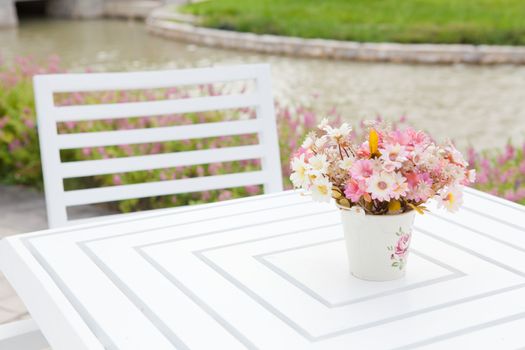 white vase and flower on the white table