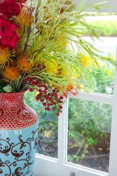 colorful vase and flower on the white table
