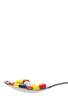 Spoon full of medicine on a white background