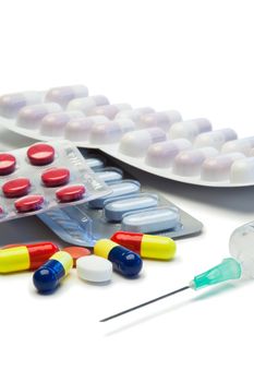 Capsules and serynge on a white background