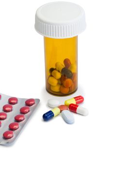 Pills with box pills and serynge on a white background