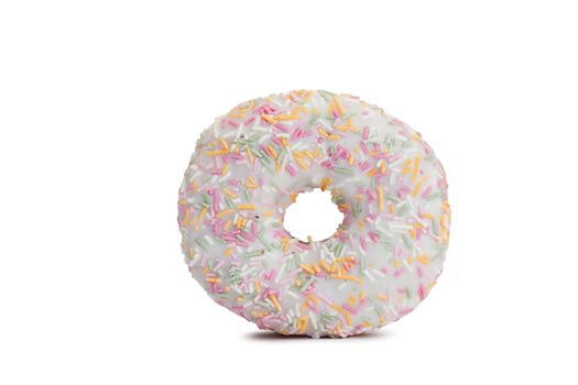 Pink Iced Doughnut covered in sprinkles isolated against white background