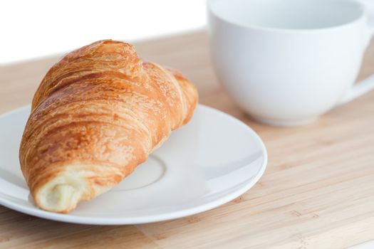 Breakfast with coffee and croissants on a white background
