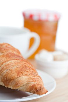 Breakfast with coffee marmalade and croissants on a white background