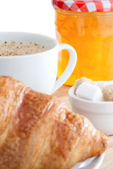 Breakfast with coffee marmalade and croissants on a white background