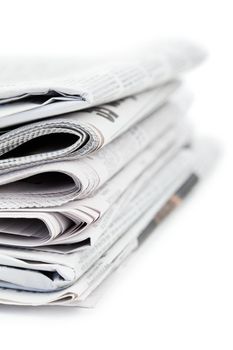 Newspapers and black glasses on a white a background