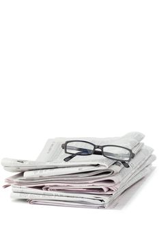 Newspapers and black glasses on a white a background