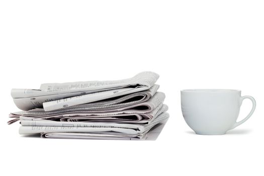 Newspapers and cup of tea on a white background