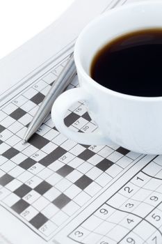 Newspapers and crossword puzzle on a white background