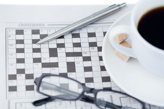 Newspapers and crossword puzzle on a white background
