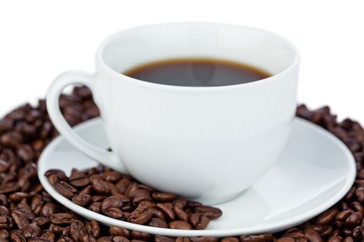 Cup of coffee and coffee beans on a white background