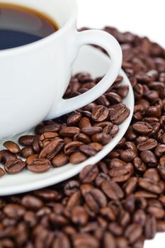 Cup of coffee and coffee beans on a white background