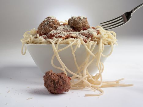 Meatballs in a bowl of spaghetti.