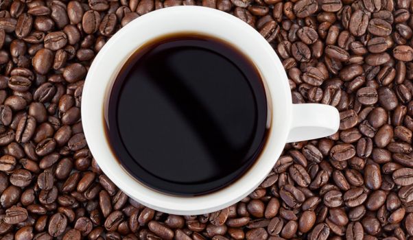 Cup of coffee on a beans background