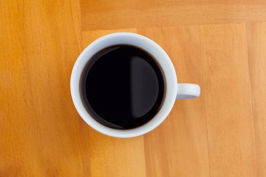White cup of coffee isolated on a desk