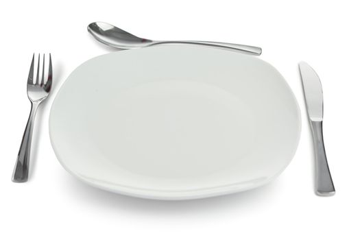 Cultery around plate on a white background