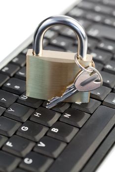 Padlock standing on a keyboard on a white background