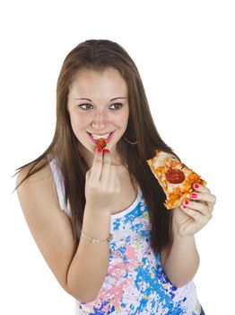 Happy teenage girl eating pizza over white background.