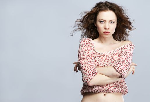 Young beautiful red-haired model studio portrait