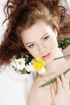 Face portrait of a beautiful model with flowers