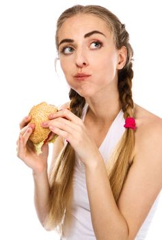 Young woman holding a hamburger and an apple, white background