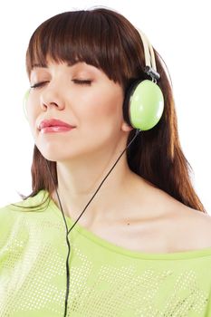 Beautiful girl with green headphones, white background