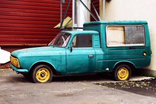 Old worn blue car outdoors