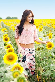 Beautiful lady walking in sunflower field