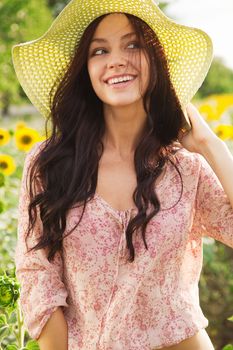 Beautiful lady walking in sunflower field