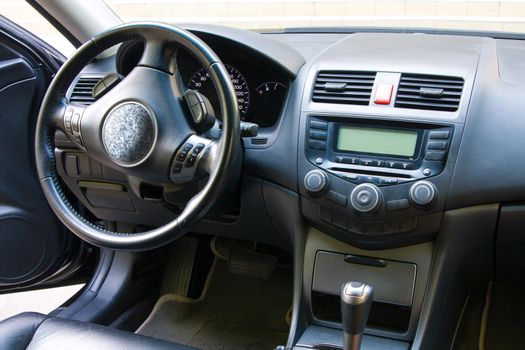 Modern car dashboard and front seats view