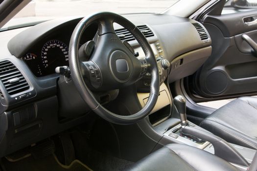 Interior of a car with view on steering wheel and dashboard