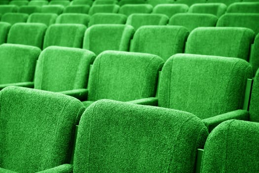 Closeup picture of chairs in empty cinema auditorium 