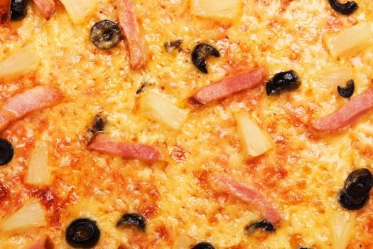 Closeup picture of pizza with olives, meat and pineapple