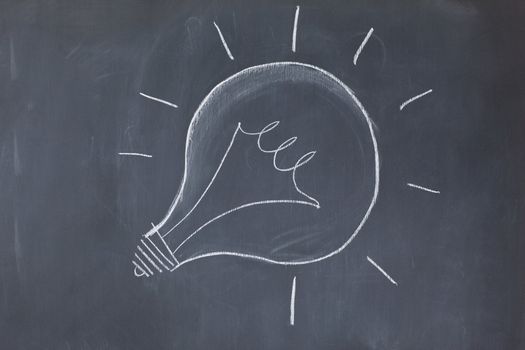Lightbulb drawn on a blackboard symbolizing ideas